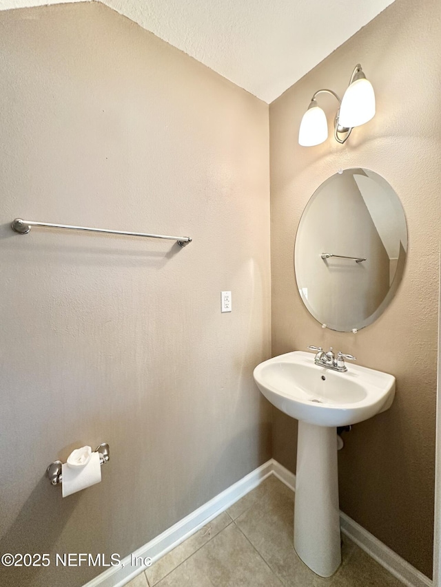 bathroom featuring baseboards and tile patterned floors