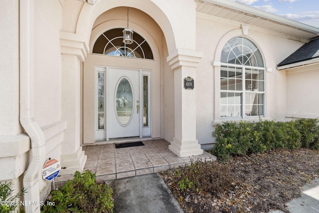 view of exterior entry featuring stucco siding