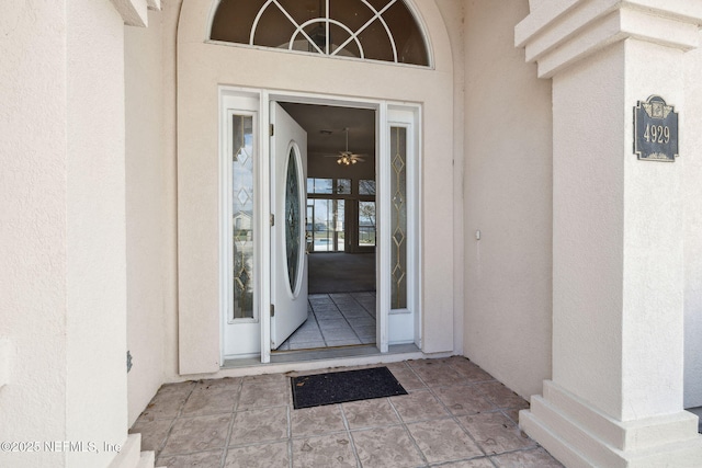 view of exterior entry with stucco siding