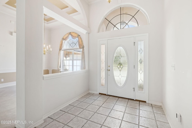 foyer with baseboards and an inviting chandelier