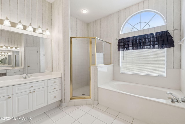 full bath featuring a stall shower, vanity, a garden tub, and tile patterned floors