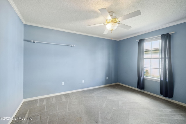 carpeted spare room featuring a textured ceiling, ornamental molding, a ceiling fan, and baseboards