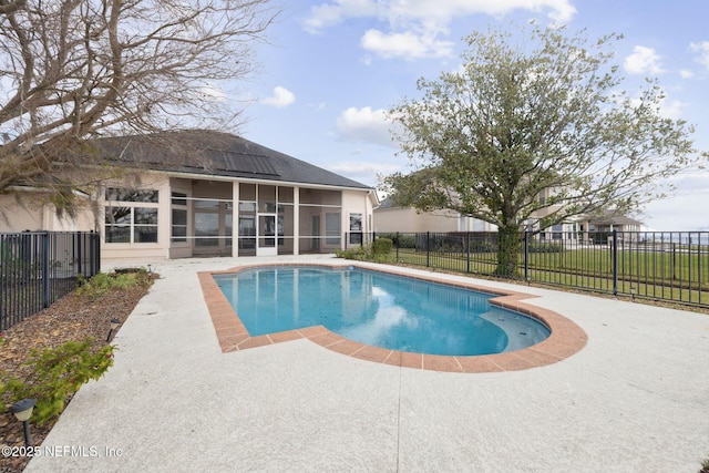 view of pool with a fenced in pool, a patio area, a sunroom, and a fenced backyard