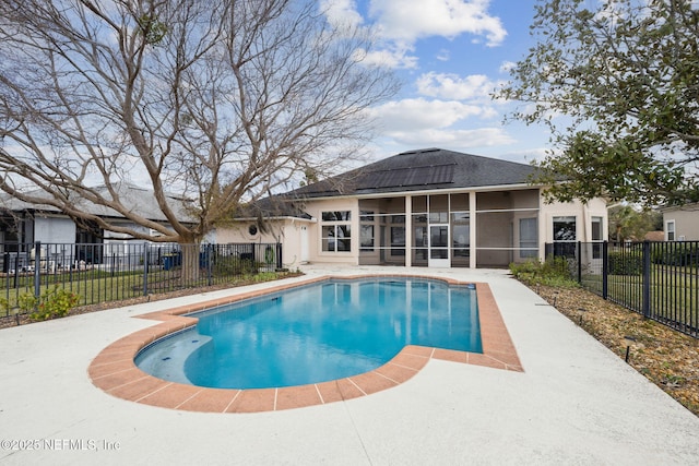 view of swimming pool featuring a sunroom, a fenced backyard, and a fenced in pool