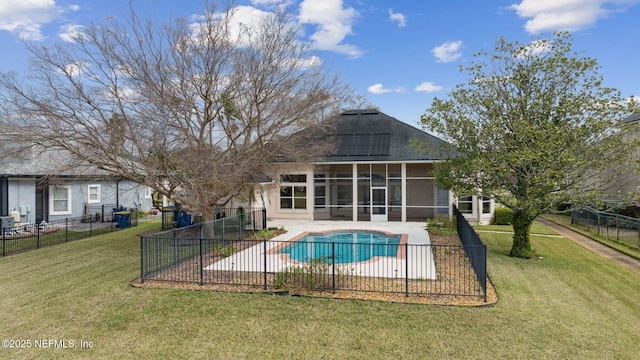 view of pool featuring a patio, a lawn, a fenced backyard, and a sunroom