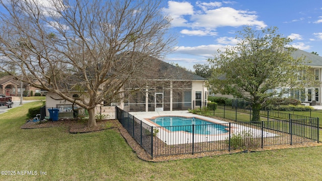 view of swimming pool with a yard, a patio, fence, and a fenced in pool