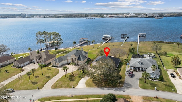 birds eye view of property with a residential view and a water view