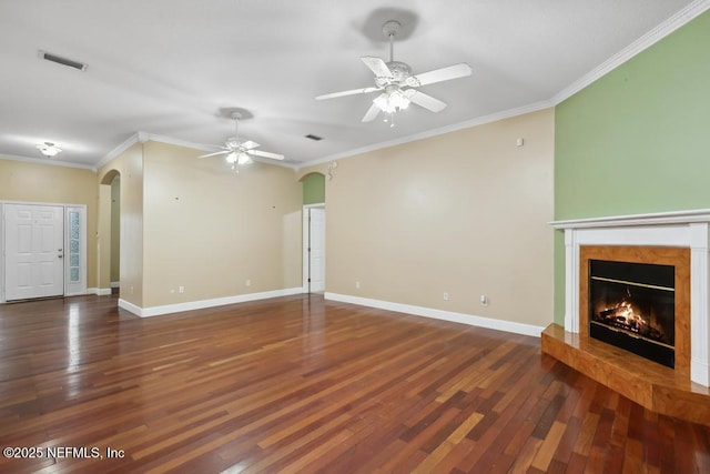 unfurnished living room featuring arched walkways, a premium fireplace, visible vents, and hardwood / wood-style flooring