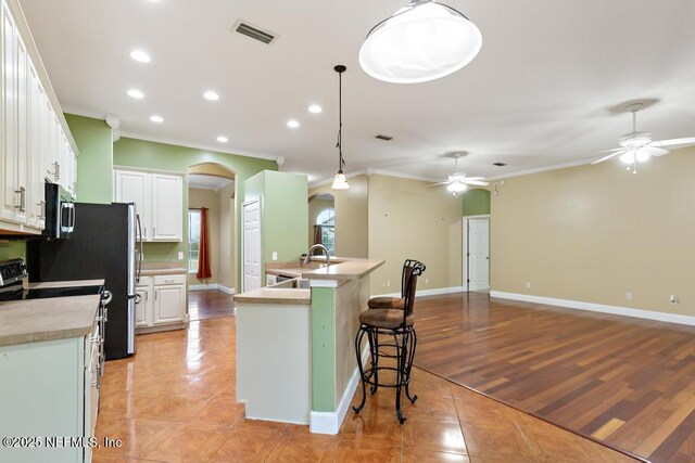 kitchen featuring light tile patterned floors, visible vents, appliances with stainless steel finishes, and ceiling fan