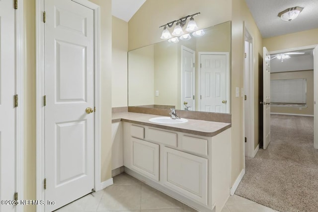 bathroom with vanity, baseboards, and tile patterned floors