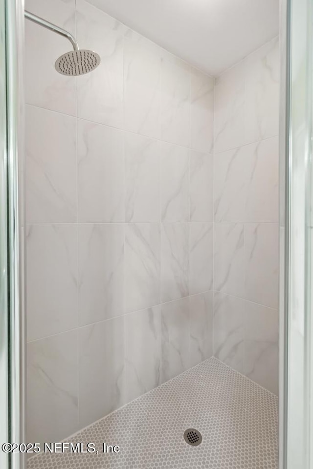 full bath featuring a tile shower