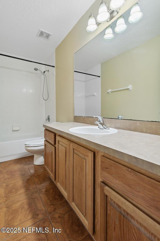 bathroom featuring bathtub / shower combination, toilet, vanity, visible vents, and tile patterned floors