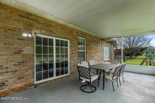 view of patio / terrace featuring a playground and outdoor dining space