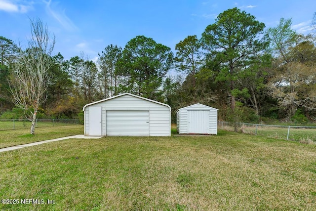 detached garage with fence and a storage unit