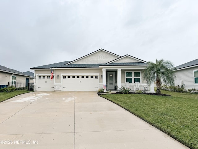 view of front of property featuring an attached garage, a porch, a front lawn, and concrete driveway