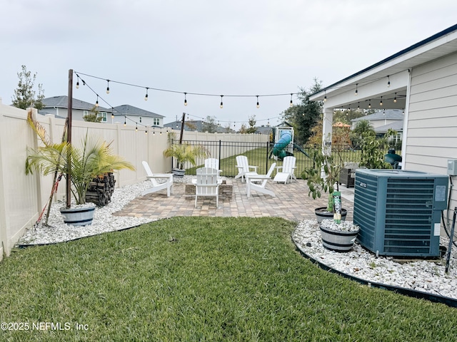 view of yard with a patio, a fenced backyard, and central air condition unit