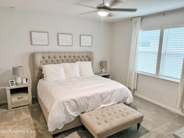 carpeted bedroom featuring ceiling fan and baseboards