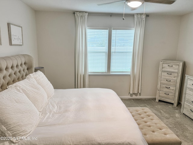 bedroom with a ceiling fan, light colored carpet, and baseboards