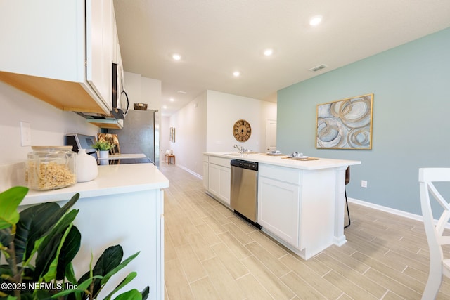 kitchen featuring visible vents, appliances with stainless steel finishes, white cabinetry, and light countertops