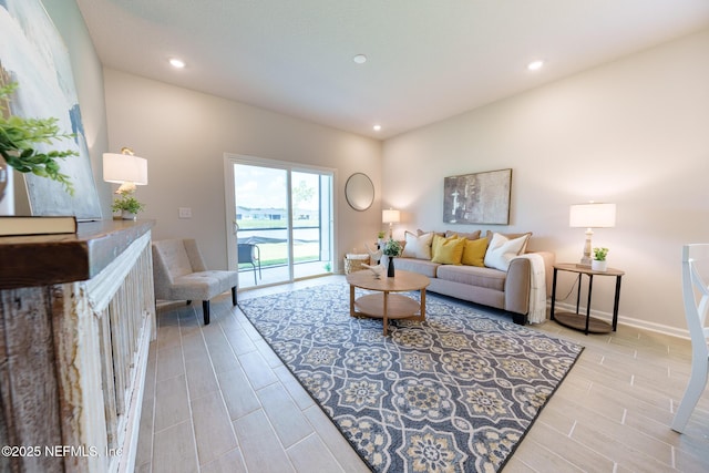 living room featuring wood finish floors, baseboards, and recessed lighting