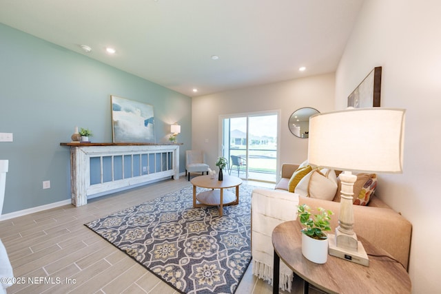 living area featuring recessed lighting, baseboards, and light wood finished floors