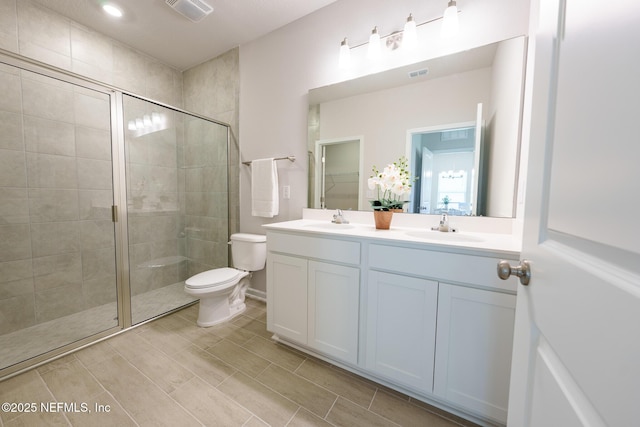 full bathroom with a stall shower, visible vents, and a sink