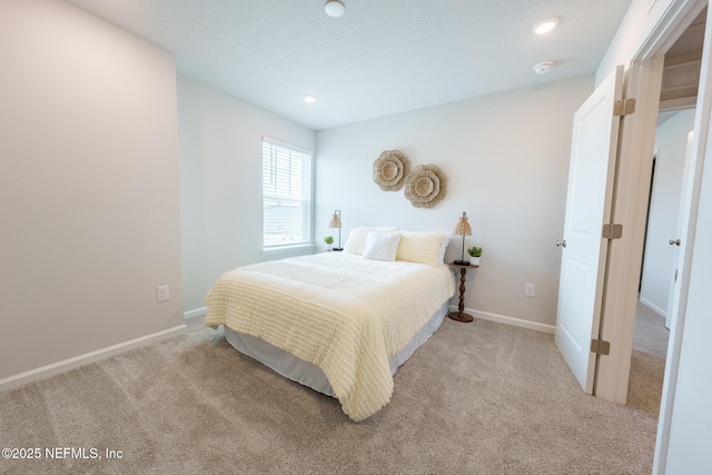 bedroom featuring recessed lighting, light colored carpet, and baseboards