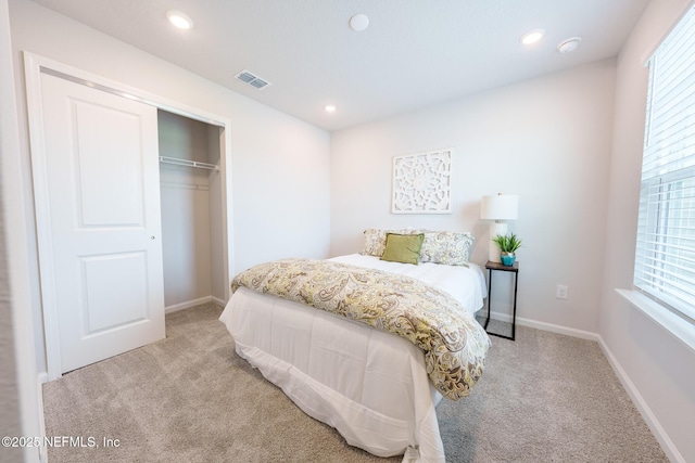 bedroom featuring multiple windows, visible vents, and light colored carpet