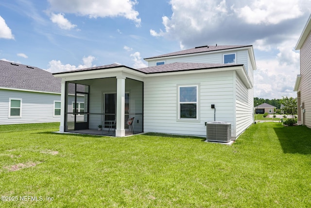 back of property featuring a sunroom, central AC unit, and a yard