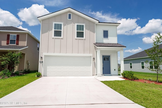 view of front facade with an attached garage, a front lawn, board and batten siding, and concrete driveway