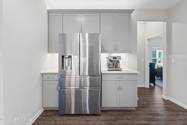 352 Bronson Pkwy, Saint Augustine, FL 32095 - kitchen featuring gray cabinetry, stainless steel fridge, decorative backsplash, and dark wood finished floors