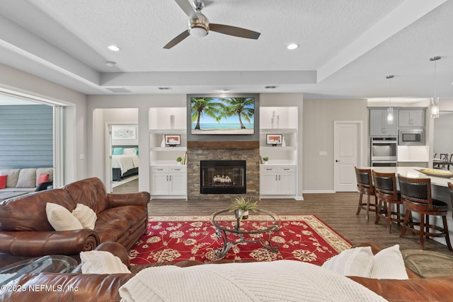 352 Bronson Pkwy, Saint Augustine, FL 32095 - living room featuring a textured ceiling, ceiling fan, wood finished floors, a glass covered fireplace, and recessed lighting