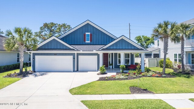 352 Bronson Pkwy, Saint Augustine, FL 32095 - view of front facade with board and batten siding, covered porch, driveway, and a garage