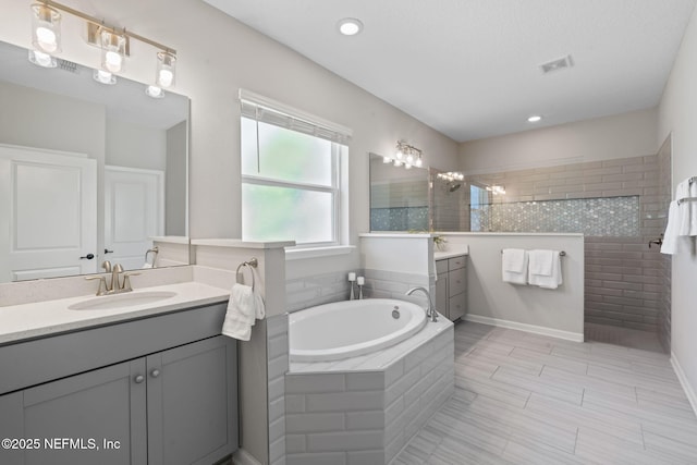 352 Bronson Pkwy, Saint Augustine, FL 32095 - bathroom featuring vanity, a garden tub, walk in shower, and recessed lighting