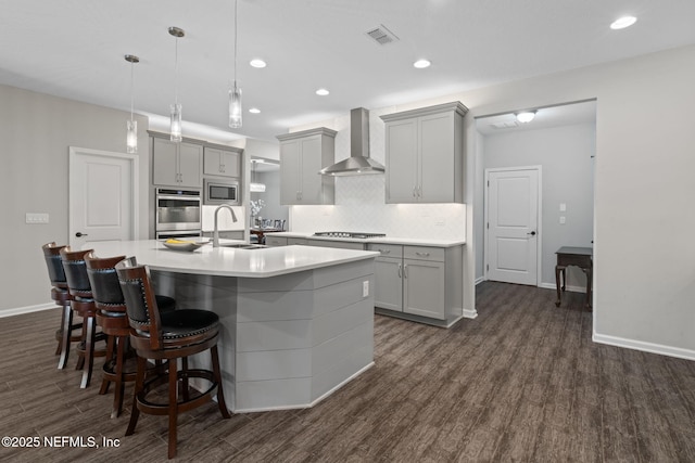 352 Bronson Pkwy, Saint Augustine, FL 32095 - kitchen featuring gray cabinets, dark wood-style floors, tasteful backsplash, a kitchen island with sink, and recessed lighting
