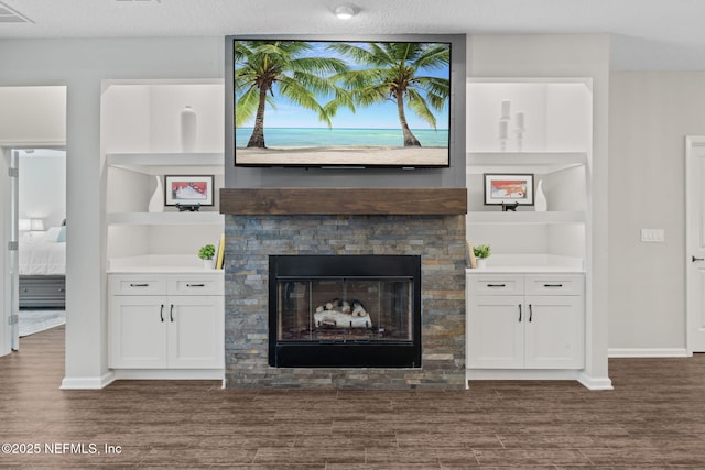 352 Bronson Pkwy, Saint Augustine, FL 32095 - living area with dark wood finished floors, a stone fireplace, and built in features