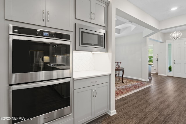 352 Bronson Pkwy, Saint Augustine, FL 32095 - kitchen featuring appliances with stainless steel finishes, tasteful backsplash, light countertops, dark wood-style floors, and recessed lighting