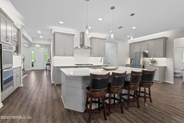 352 Bronson Pkwy, Saint Augustine, FL 32095 - kitchen with gray cabinets, dark wood-style floors, appliances with stainless steel finishes, tasteful backsplash, and recessed lighting