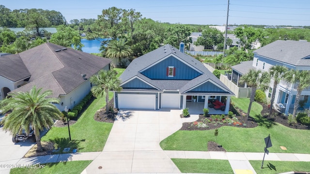 352 Bronson Pkwy, Saint Augustine, FL 32095 - view of front of house featuring board and batten siding, driveway, roof with shingles, and an attached garage
