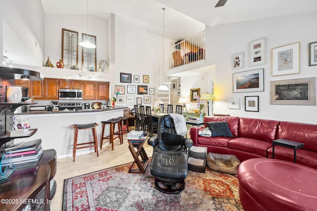 living area featuring high vaulted ceiling, a ceiling fan, and light tile patterned flooring