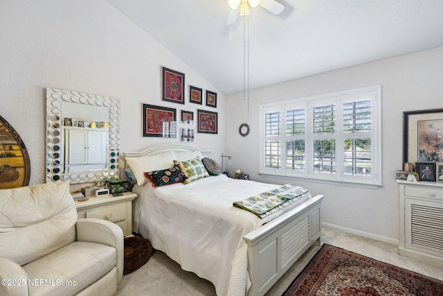 bedroom with a ceiling fan, light carpet, vaulted ceiling, and baseboards