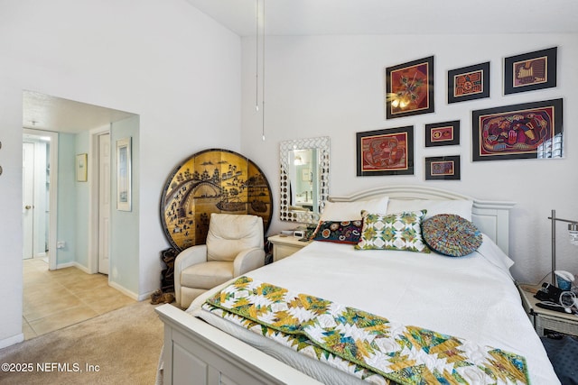 bedroom with baseboards, a towering ceiling, and light colored carpet