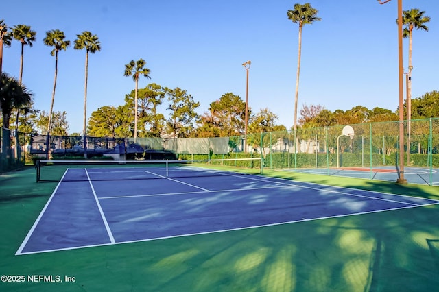 view of sport court featuring fence