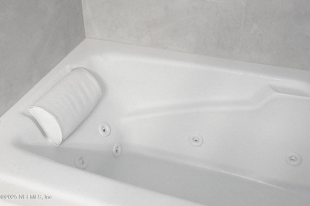 room details featuring a tub with jets