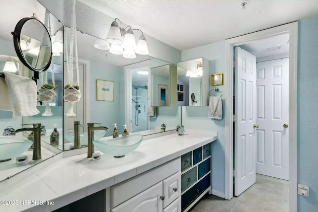 full bathroom with a shower, vanity, and tile patterned floors