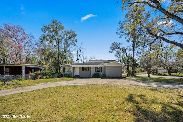 view of front of home with driveway, a front lawn, and fence