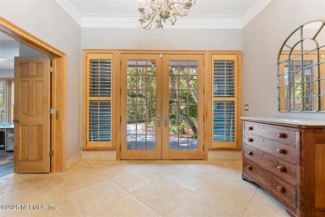 entryway featuring crown molding, a notable chandelier, french doors, and baseboards