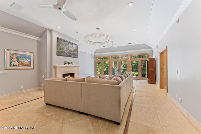 living room with baseboards, recessed lighting, a warm lit fireplace, ceiling fan, and ornamental molding