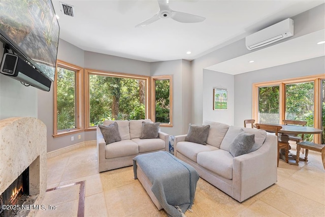 living area featuring a high end fireplace, visible vents, ceiling fan, recessed lighting, and a wall mounted AC