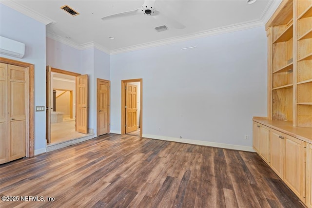 unfurnished bedroom featuring visible vents, baseboards, an AC wall unit, ornamental molding, and dark wood-style floors